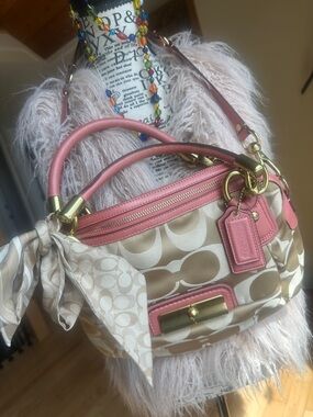 Coach Gold-Tone Lock Wristlet with Pink Trim